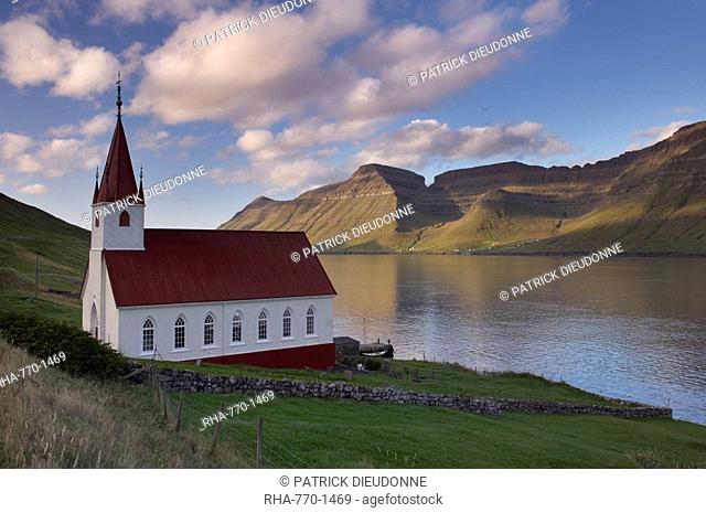 Church built in 1920 at Husar, Kalsoyarfjordur and Kunoy hills in the distance, Kalsoy, Nordoyar, Faroe Islands Faroes, Denmark, Europe