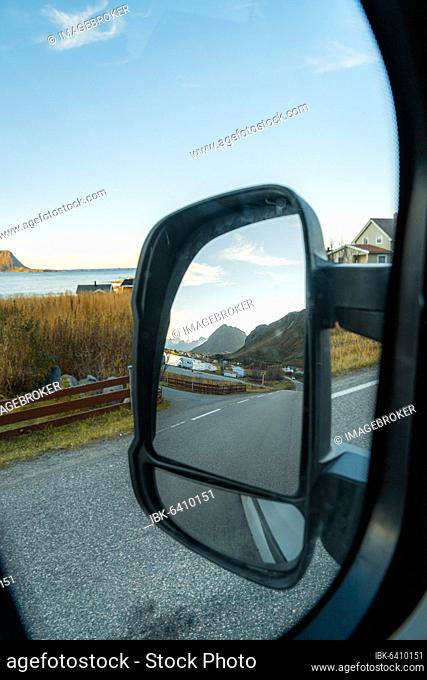 View of the fjord landscape through Campervan side mirror, Ramberg, Lofoten, Norway, Europe