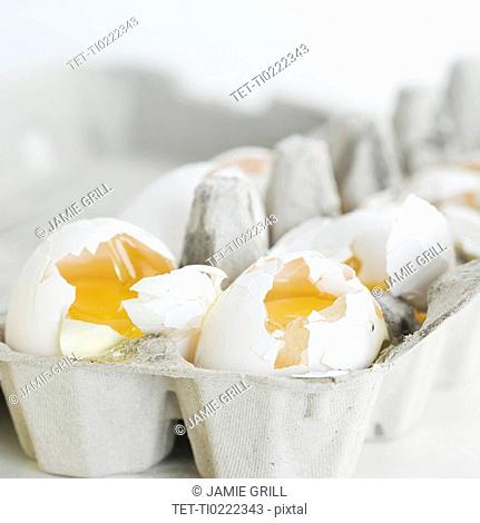 Close up of broken eggs in carton