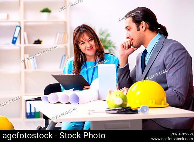 Businessman and female doctor discussing construction project