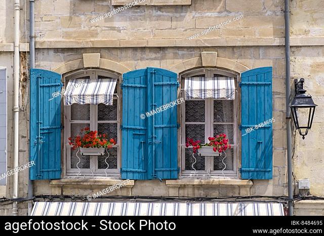 Window with blue shutters and red geraniums, Arles, Provence-Alpes-Côte d'Azur, France, Europe