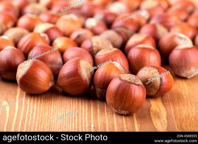 Closeup view of many hazelnuts on a table
