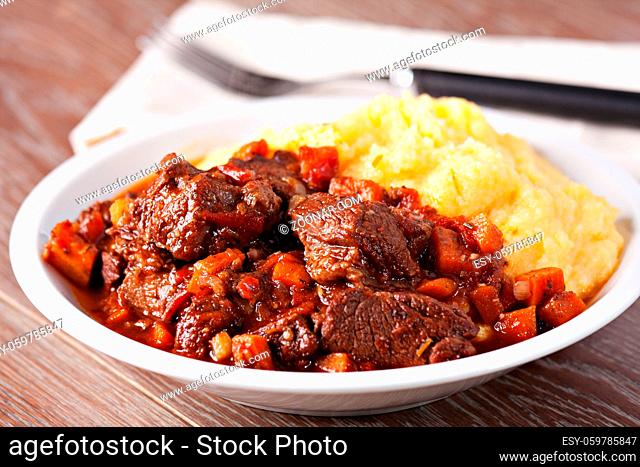 Delicious beef stew with mushrooms and polenta. High quality photo