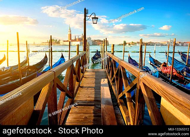 Condolas and wooden pier in Venice, Italy