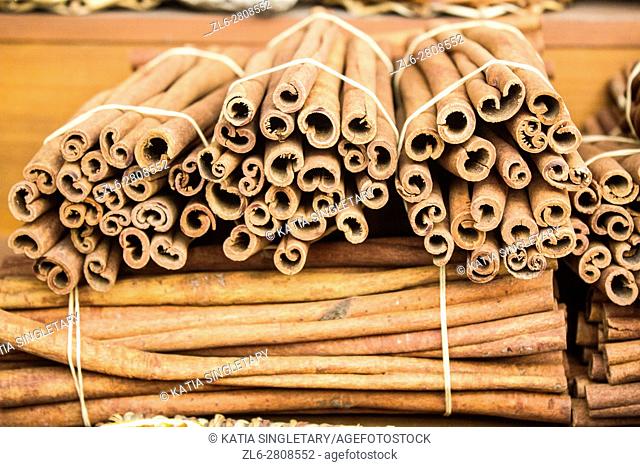 Cinnamon sticks bundle together on displays and for sale in an outdoor market in Athens, Greece, Europe