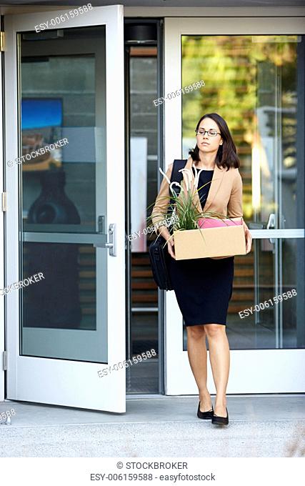 Redundant Businesswoman Leaving Office With Box