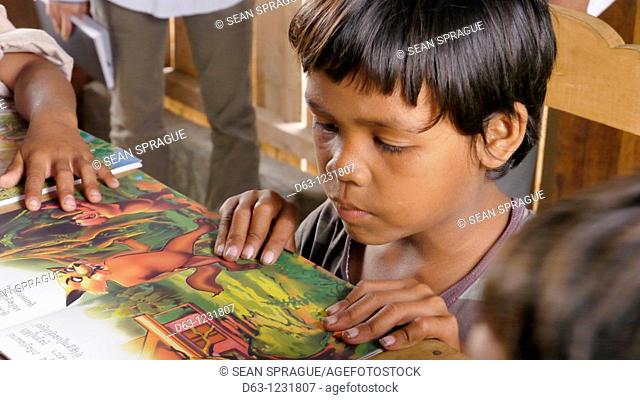 CAMBODIA. Katot village, inhabited by the Prov tribal group, Stung Treng district  Library and literacy building provided by DPA and SCIAF  Children reading...