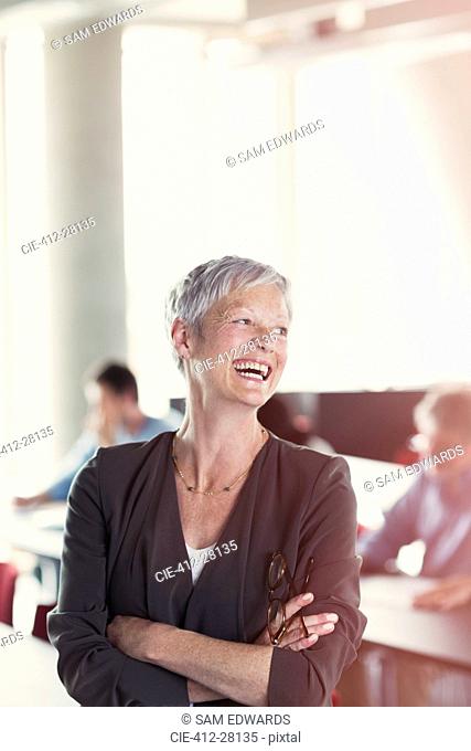 Laughing senior woman in adult education classroom