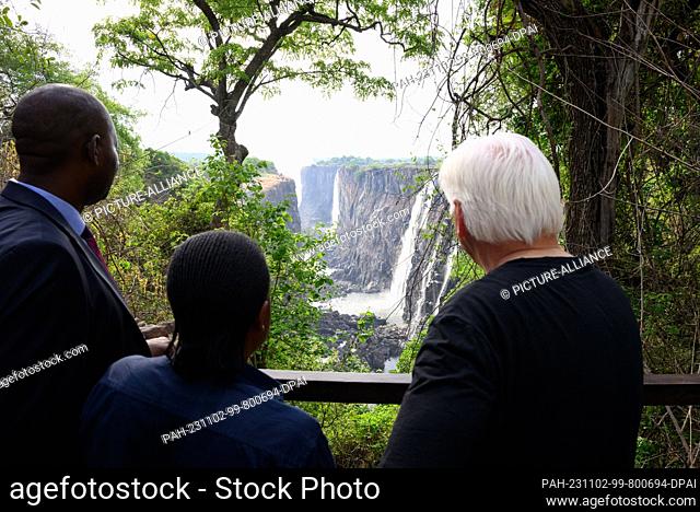 02 November 2023, Zambia, Livingstone: German President Frank-Walter Steinmeier (r) visits the Victoria Falls on the border between Zambia and Zimbabwe