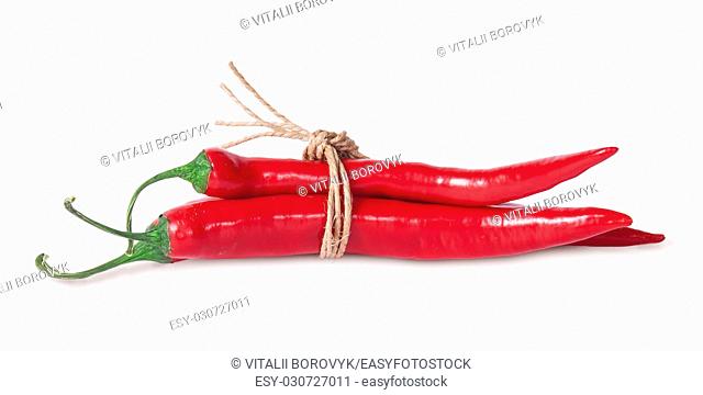 Red chili peppers tied with a rope isolated on white background
