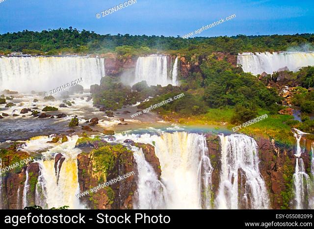 Boiling water creates rainbow. The concept of extreme and exotic tourism. Iguazu Falls National Park - grandiose complex of waterfalls on the border of...