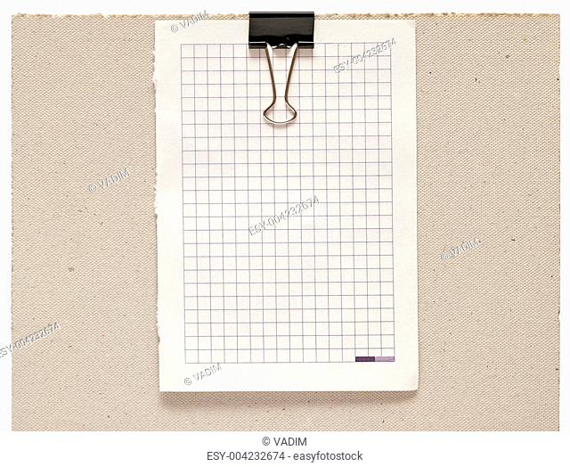 Black clip and blank note book paper