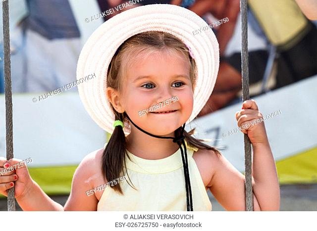Little girl in a hat smiling. Shallow depth of field