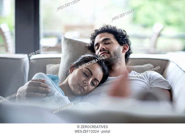 Young couple sleeping on a couch