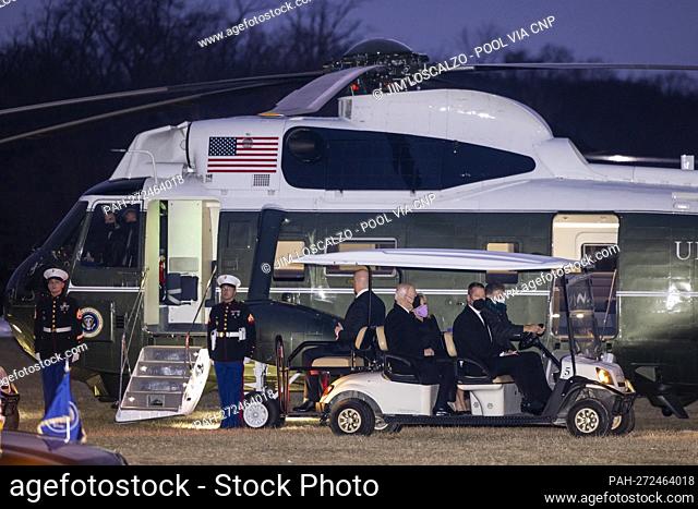 US President Joe Biden (C) and First Lady Jill Biden (C-R) ride in a gold cart next to Marine One as they arrive at George Washington’s Mount Vernon home to...