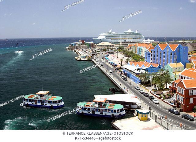 The port city of Willemstad, Curacao, Netherland Antilles with ferry boats and the cruise ship Adventure of the Seas