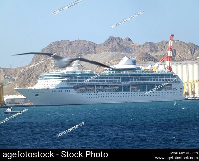 A ship docks at the port. Muscat, Oman’s port capital, sits on the Gulf of Oman surrounded by mountains and desert. Oman, officially the Sultanate of Oman