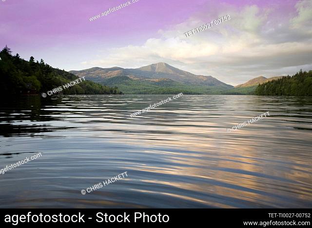 United States, New York, Lake Placid, Calm Lake Placid and Whiteface Mountain at sunset