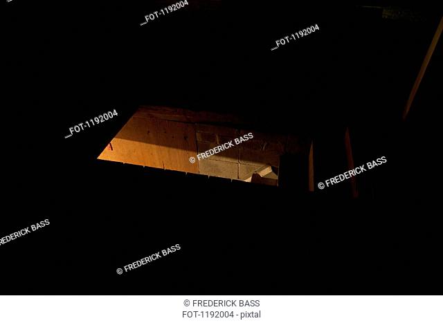 Dark attic with light seen through door