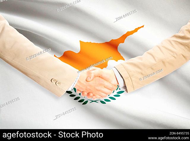 Businessmen shaking hands with flag on background - Cyprus