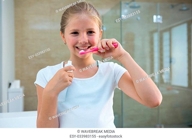 Portrait of girl brushing teeth