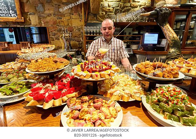 Waiter serving cider, Pintxos, Bar Taberna Aralar, Parte Vieja, Old Town, Donostia, San Sebastian, Gipuzkoa, Basque Country, Spain