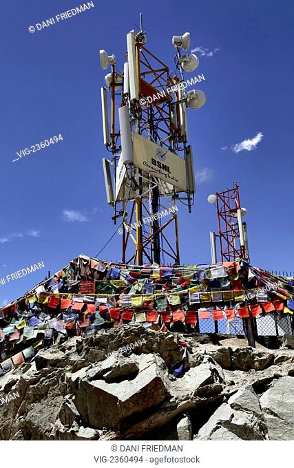 Prayer flags surround a cellular phone relay tower on a mountaintop in Leh, Ladakh. - LEH, LADAKH, INDIA, 13/07/2010