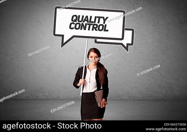 Young business person in casual holding road sign with QUALITY CONTROL inscription, new business idea concept