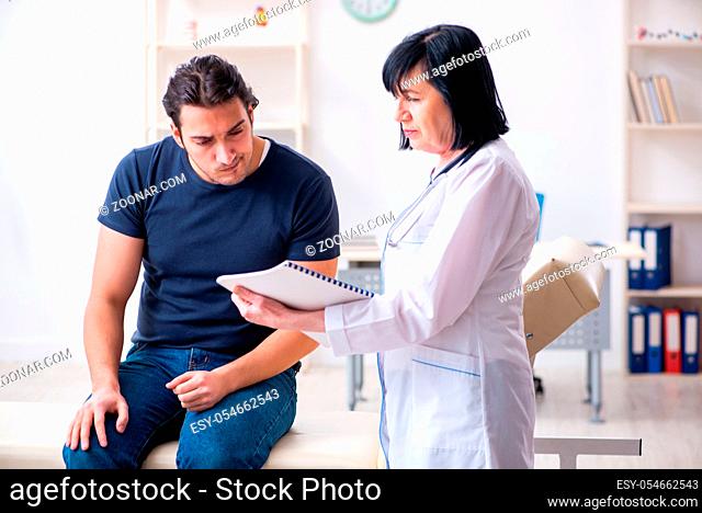 The young male patient visiting aged female doctor