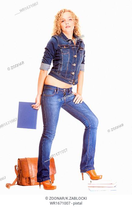 Denim fashion. Full length student girl in blue jeans bag books