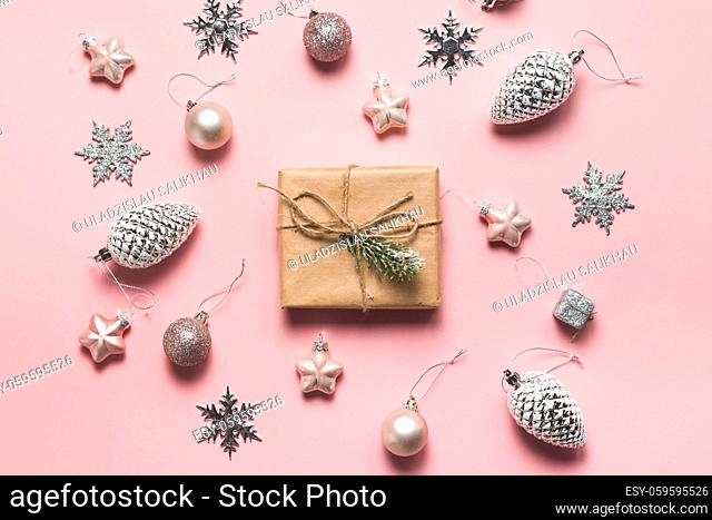 Christmas greeting card. Gift boxes and Christmas decorations layout on pink background, top view. Flat lay. Christmas and Holidays greeting card