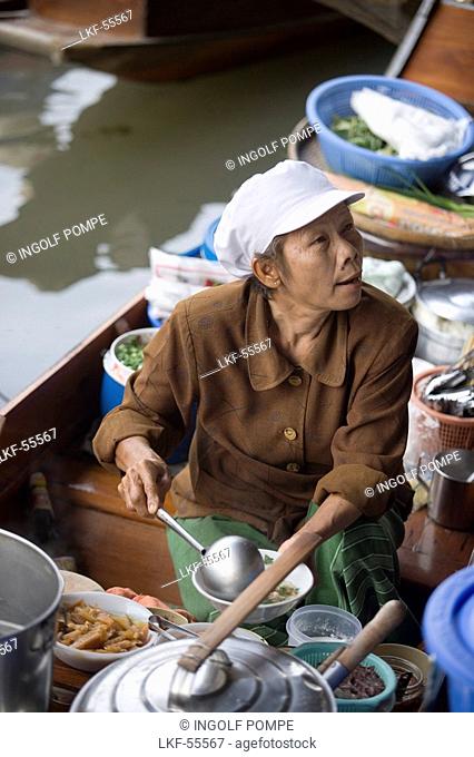 Woman offering food at Floating Market, Damnoen Saduak, near Bangkok, Ratchaburi, Thailand