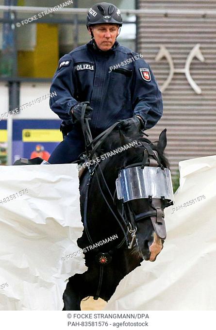 An equestrian of the police riding team rides through a paper wall during a show on the occasion of the Horse-State Lower Saxony Day at the Lower Saxony Hall in...