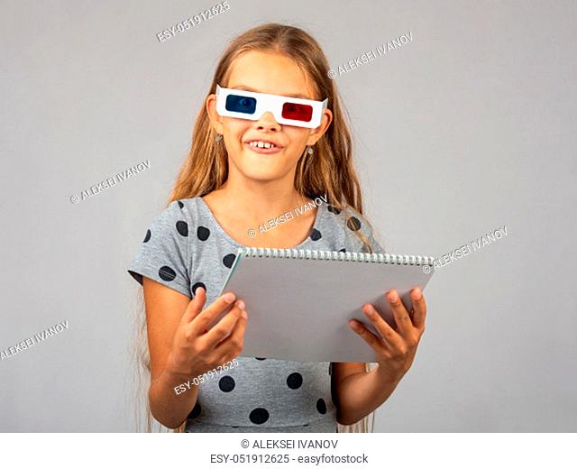 The girl in the colored 3D glasses, made using the anaglyph technology of the 3D glasses, looked into the frame