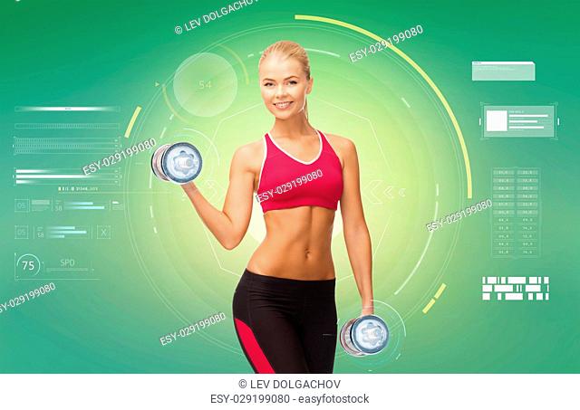 sport, fitness, exercising, technology and people concept - happy young sporty woman with dumbbells flexing biceps over green background