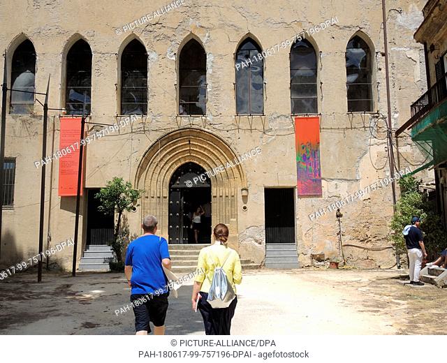 16 June 2018, Palermo, Italy: Visitors walk towards the Palazzo Forcella De Seta in Palermo. The European exhibition of contemporary art is taking place in...