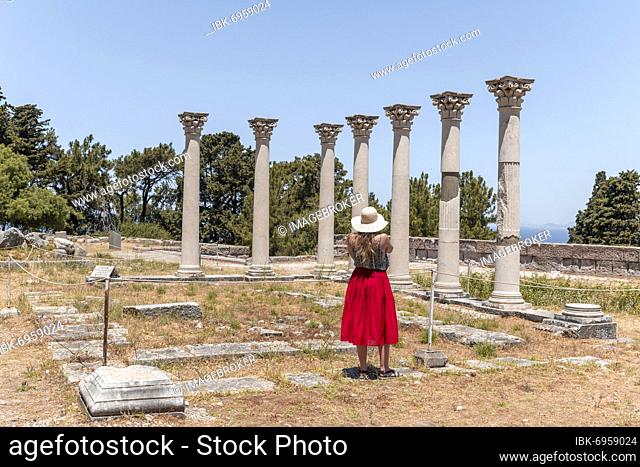 Young woman with dress in front of ruins with columns, Former temple, Asklepieion, Kos, Dodecanese, Greece, Europe