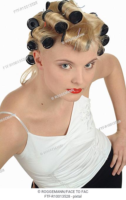 Happy blond woman with curlers in her hair