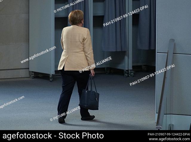 07 September 2021, Berlin: Chancellor Angela Merkel (CDU) leaves after debates in the German Bundestag. In what is expected to be his last debate Bundestag of...