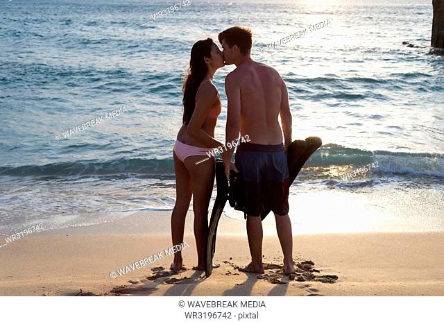 Couple kissing each other on the beach