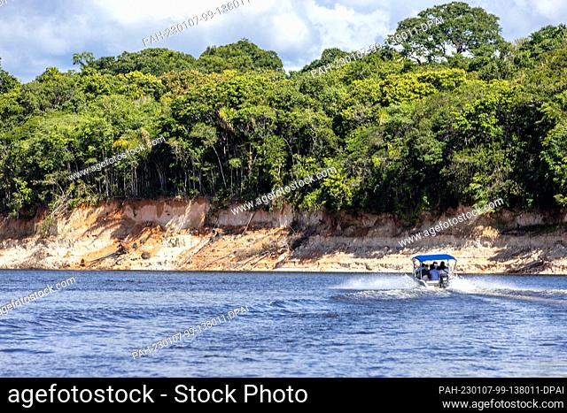 02 January 2023, Brazil, Manaus: A boat sails on a river in the Amazon rainforest. The world's largest tropical rainforest is crisscrossed by thousands of...