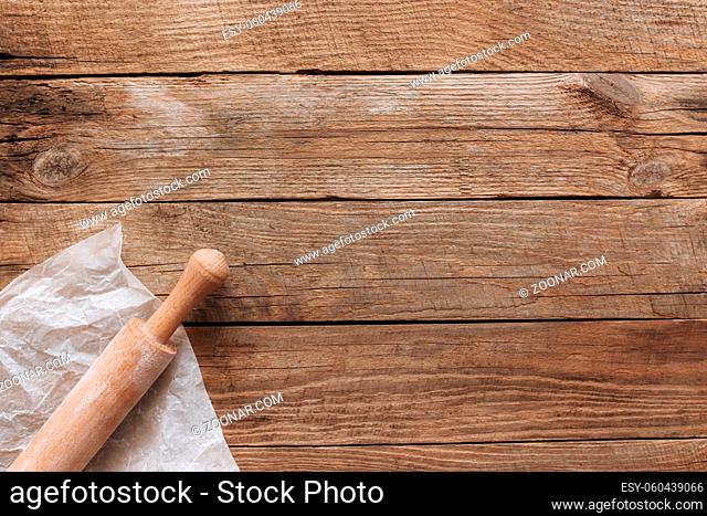 Ingredients for baking and kitchen utensils on old wooden background. Cooking baking dough, preparing flour, rocking pin, parchment paper