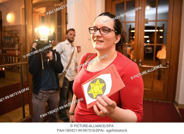 20 April 2018, Germany, Konstanz: Student Sophie Arzt holding a Star of David and the booklet for the play after the premiere of the play ""Mein Kampf"" by...