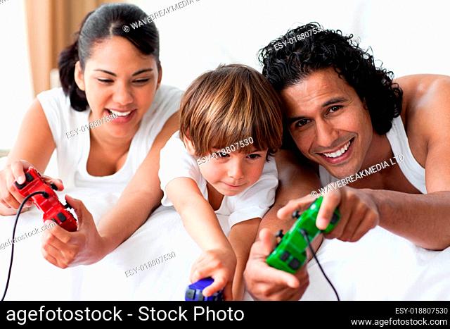 Portrait of smiling parents playing video games with their son
