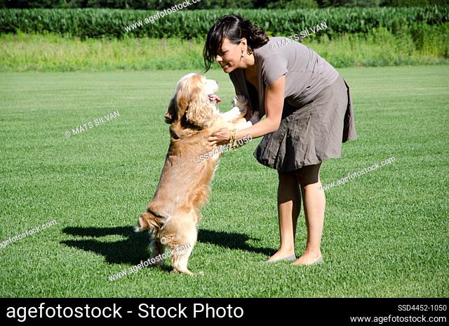 Woman Playing with Her Dog on the Grass in Switzerland