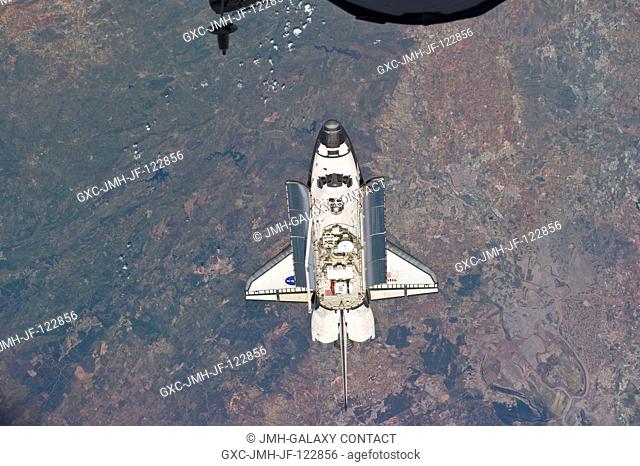 Backdropped by a colorful Earth, space shuttle Atlantis is featured in this image photographed by an Expedition 23 crew member as the shuttle approaches the...