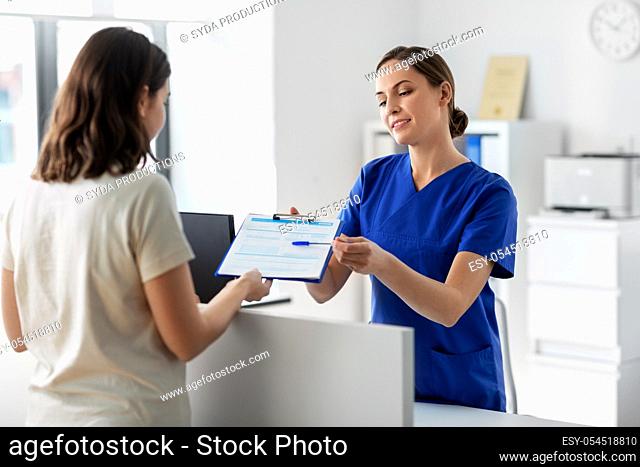 doctor with clipboard and patient at hospital