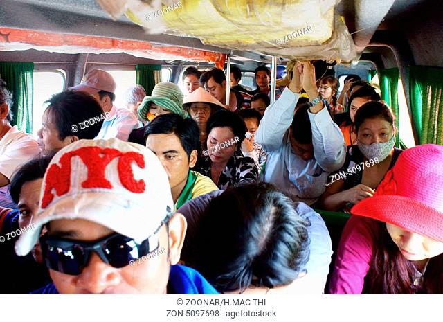 People sit in overcrowded in passenger boat