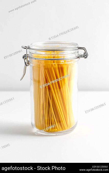 close up of jar with pasta on white table
