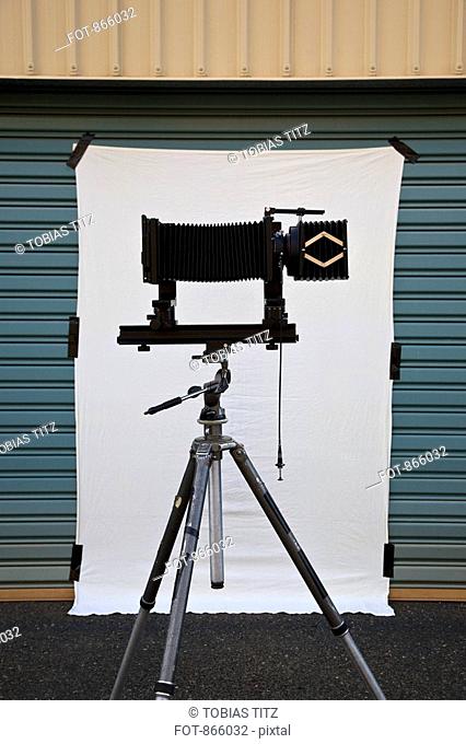 A old-fashioned camera and back drop set up for a photo shoot